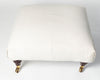 Vintage upholstered ottoman footstool on castors