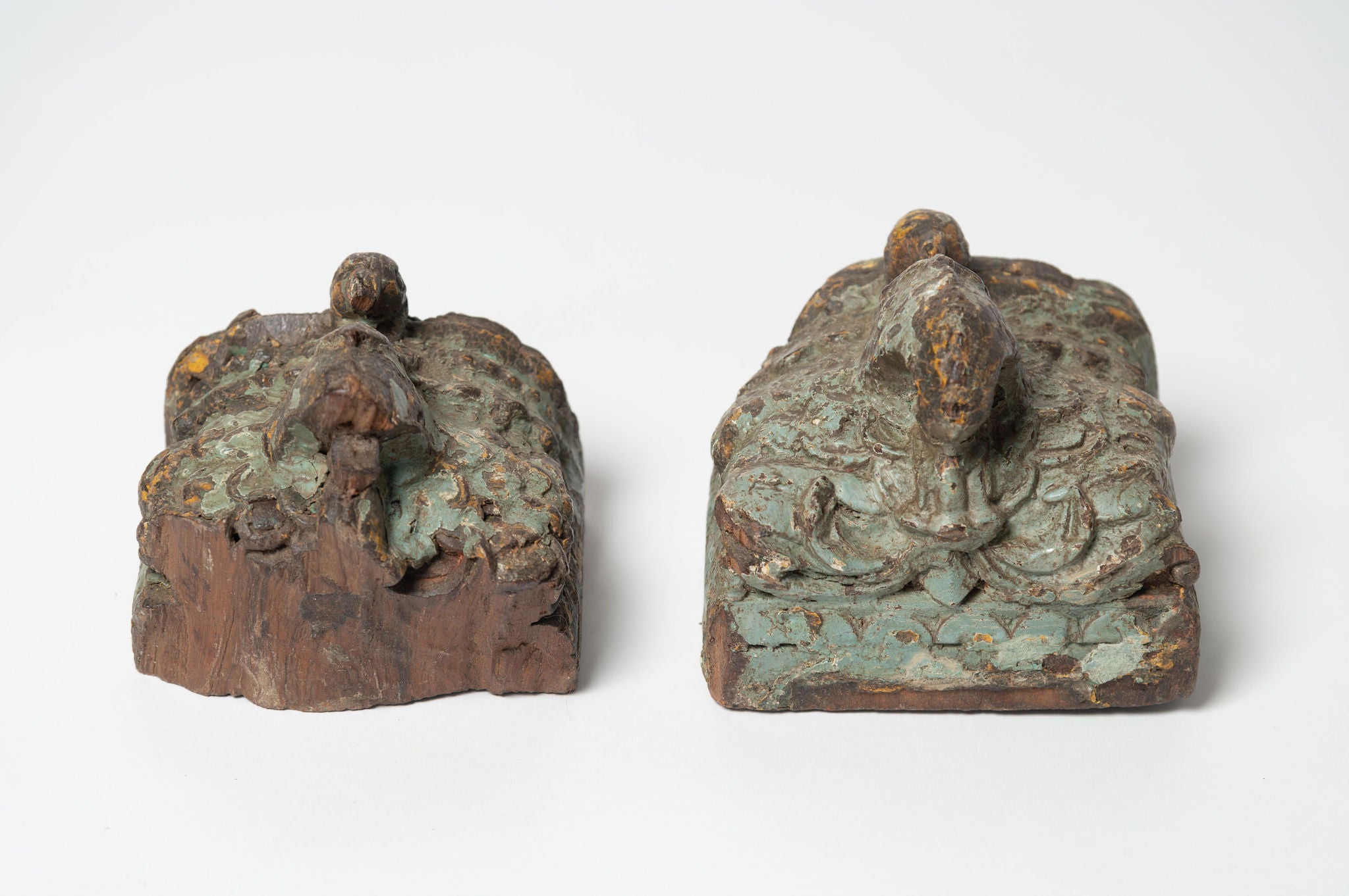 Two reclaimed Indian architectural salvage wall sconces, with original green paint