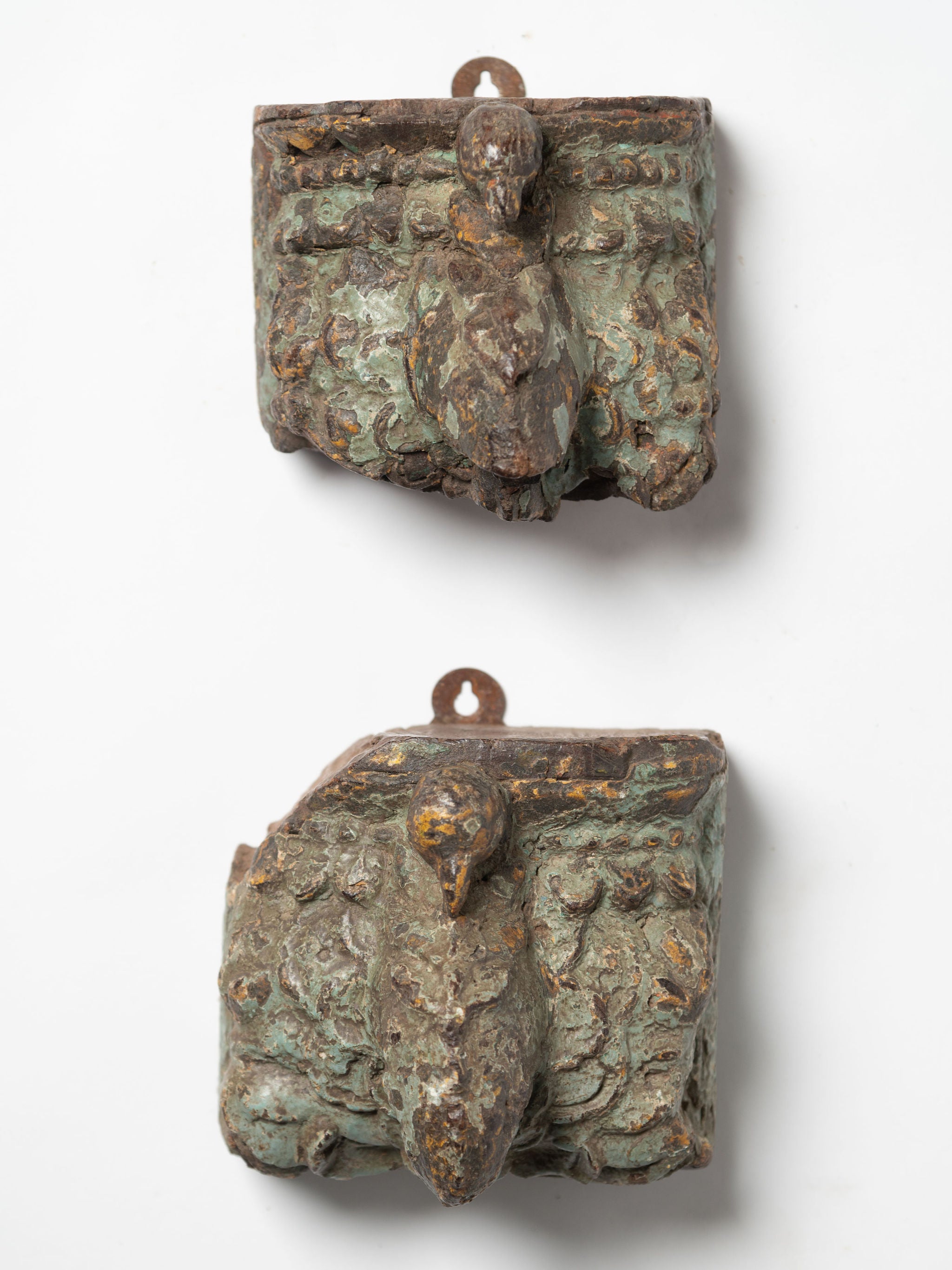 Two reclaimed Indian architectural salvage wall sconces, with original green paint